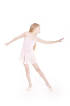 girl dancing in pink ballet suit in studio with white background