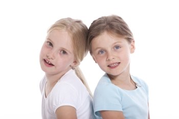 two young female friends against white background