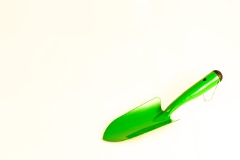 Green garden shovel isolated on white background with copy space
