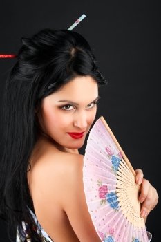 Portrait of a girl in the Asian image, with a fan.