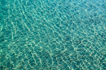 Background - the seabed through the sparkling clear water