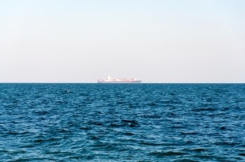 The Loaded Container Carrier far on horizon.