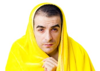 Sick man with fever in a yellow blanket