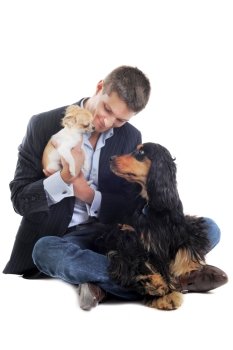 man withe a  purebred english cocker and chihuahua  in a studio