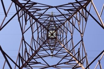 Transmission tower. Transmission tower as seen from below towards a blue sky