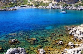 Crystal clear waters at in a torquois hidden bay in Rhodes Greece