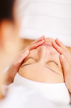 Close-up shot of a relaxed woman during professional facial massage