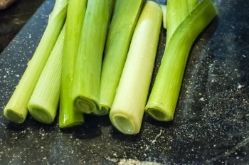 Stalks of leek, washed and prepared for cutting and cooking