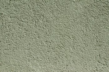 Green colored new plaster house wall facade closeup as background