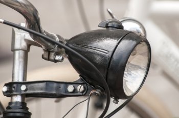 Black colored retro vintage bicycle headlight closeup