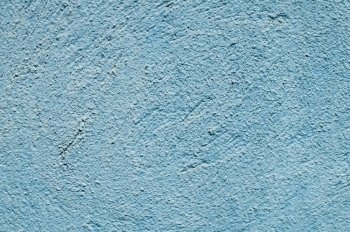 Blue painted plaster house wall closeup as background