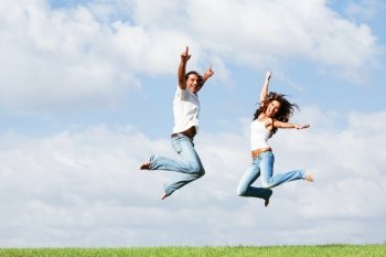 Happy couple jumping high of joy