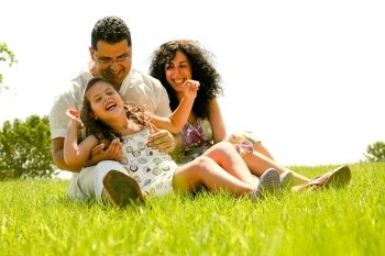Couple enjoying on nature background with daughter
