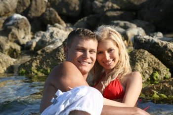 Loving couple at the beach in front of camera
