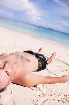 Man Sunbathing at the Tropical Beach