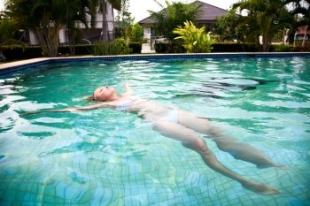 Beautiful woman relaxing in the pool