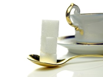 lump sugar with spoon and cup. lump sugar