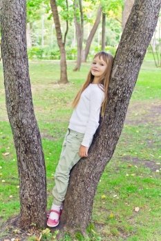 Photo of cute girl in summer sit on tree