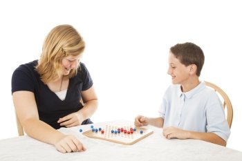 Brother and sister playing a board game together.  Isolated on white.  