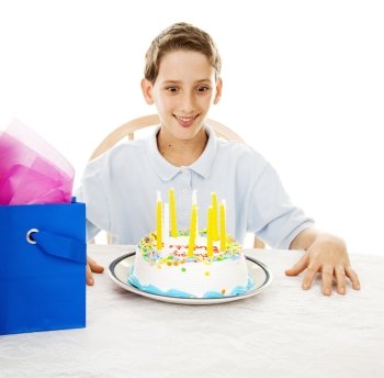 Cute little boy ready to eat his birthday cake. White background.