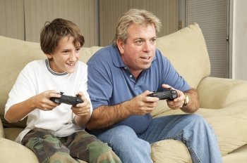 Father and son or uncle and nephew, playing video games at home.  