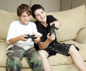Two brothers at home playing video games together.  