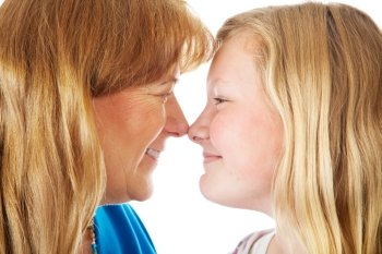 Pretty blond mother and daughter face off nose to nose.  Closeup.