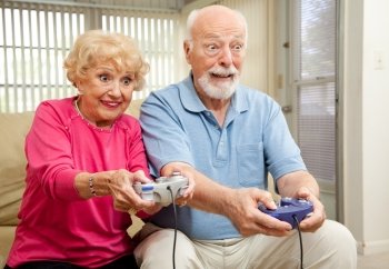 Senior couple having a great time playing video games.  