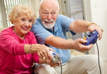 Senior couple having fun playing video games.