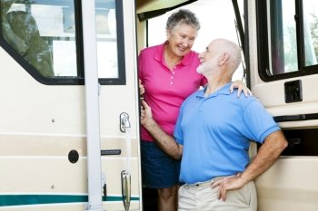 Attractive senior couple traveling by motor home.