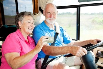 Senior couple using GPS to navigate their vacation motor home.  