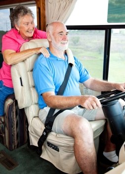 Senior couple enjoys riding in their motor home.  