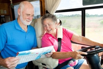 Senior couple in their motor home consulting a map.  