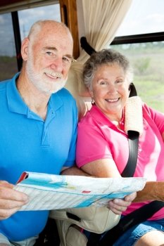 Portrait of a senior couple traveling together in their motor home.  