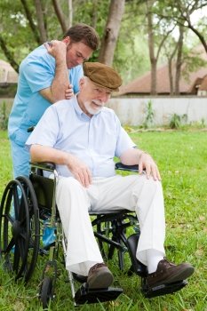 Disabled senior man receiving massage therapy in a lovely outdoor setting.  
