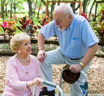 Senior man flirting with beautiful senior lady in the park.  