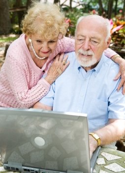 Senior couple checks their e-mail on the computer. 