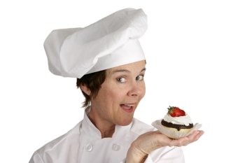 A friendly female chef holding a strawberry cheesecake tart.  Isolated on white.