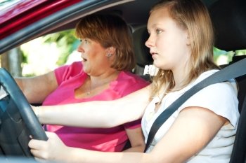 Teenage driver and her mother about to have a car accident.  
