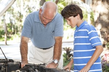 Father and son working together on the car engine.  