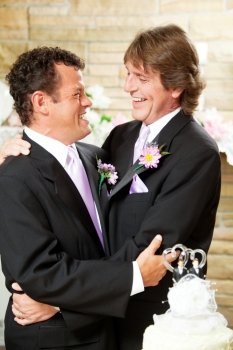 Gay male couple embracing on their wedding day.  