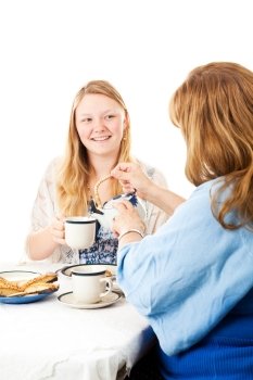 Mother and daughter having a Mother’s Day tea party.  Mom is pouring tea.  White background