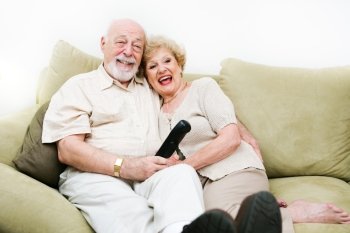 Senior couple relaxing at home enjoy watching television.  