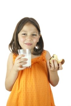 Girl drinking a glass of milk and eating a piece of cake