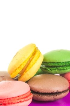 pile of Tasty colorful macaroons on white background