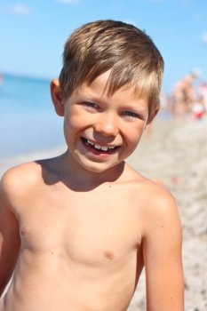Portrait of a smiling boy on the sea beach