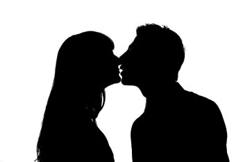 Couple theme. Silhouettes of kissing man and woman.