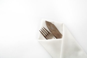An image of a fork and knife in napkin