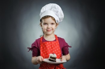An image of a girl in a white hat with a cake on a plate