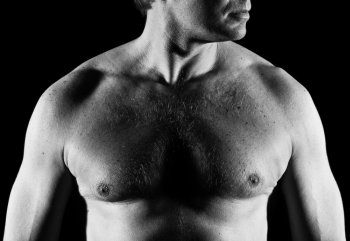 Handsome caucasian man, close-up of chest, black and white image